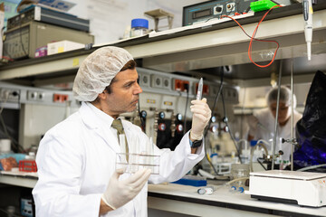 Skilled male technical expert provide analysis service in modern science research laboratory,...
