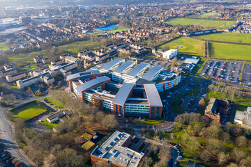 Aerial drone photo of main building of the Pinderfields Hospital, located in Wakefield West Yorkshire in the UK showing a Birds Eye view of the hospital grounds and car park in the winter time