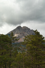 The Pedraforca is an emblematic mountain of Catalonia located in the Cadi mountain range. A mountain that has two peaks separated by a large col. Vertical photo of landscape and background in spring.