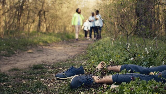 Rescuers group finding murdered barefoot victim in the forest, scared people calling the police. Mysterious horror manslaughter in the woods, civilians found a dead body, grim murder. Camera B.