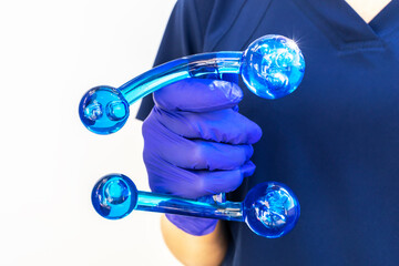Doctor Holds Blue Acrylic Back, Leg, Neck Massage Tool with Gloved Hand. Deep Tissue Massage, Thumb...