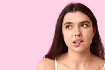 Young woman with beautiful lips on pink background, closeup