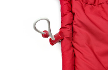 Plastic elastic waist band buckle on red winter puffy jacket close up