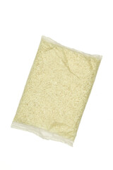 Naklejka premium Small bag full of rice isolated on white background.