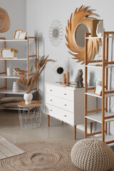 Fototapeta premium Interior of stylish living room with golden mirror and commode