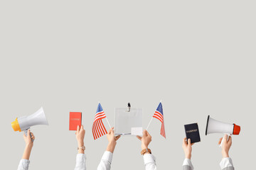 Hands holding ballot box, USA flags, passports and megaphones on white background. Election concept