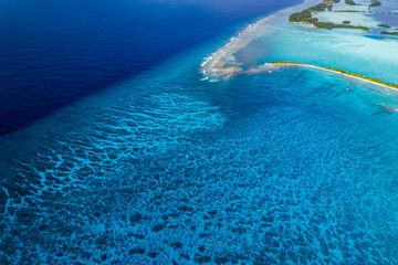 High aerial view of eastern end of Palmyra Atoll with Barren Island and terrace reef stretching out into the Pacific Ocean