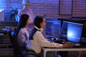 Female programmers working in office at night