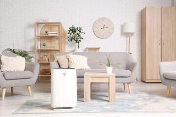 Interior of living room with sofa, table and air humidifier