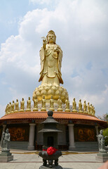 BANGKOK, THAILAND - May 16, 2024: A large golden statue of the Goddess Kuan Yin Set tall and...
