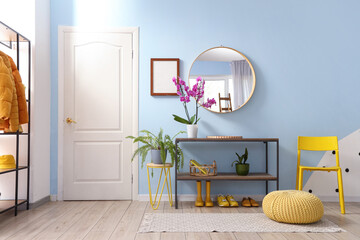 Interior of hall with mirror and orchid flower on shelf
