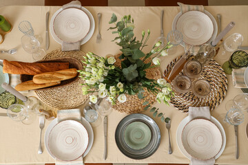Beautiful table setting with eustoma flowers for wedding celebration in room, top view