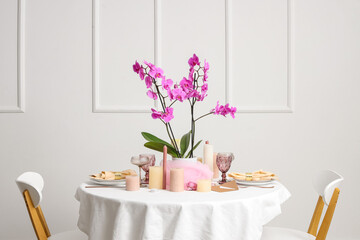 Beautiful table setting with orchid flower for wedding celebration in room