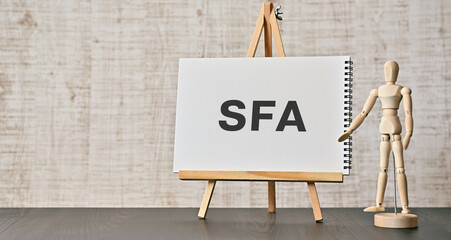There is notebook with the word SFA. It is an abbreviation for Sales Force Automation as...