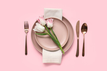 Stylish table setting with beautiful tulips on pink background