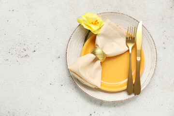 Stylish table setting with golden cutlery and beautiful flower on white background