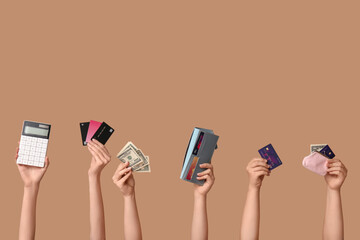 Female hands with credit cards, calculator, wallet, money and piggy bank on brown background