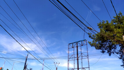 random Messy electrical cables and wires on electric pole on sky background.
