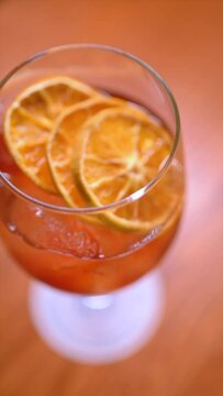 Vertical video of premium cocktails on wooden table. Slow motion cocktail videos. Concept of mixology and cocktails.