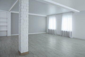 Empty room with large windows and laminated floor