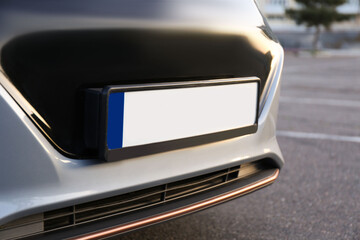 Vehicle registration plate on car outdoors, closeup