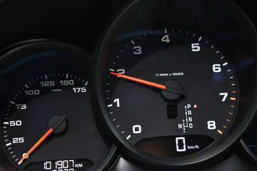 Speedometer and tachometer inside of modern car, closeup