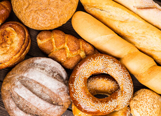 Many mixed breads and rolls shot from above.