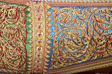 Closeup of Beautiful Traditional Thai style flower pattern decorative, stucco gold paint in temple at Thailand.