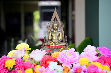Sprinkle water onto the Golden Buddha statue with rose and jasmine scented water in Songkran...