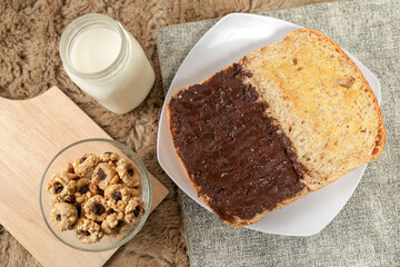 Bread with chocolate spread filling, milk and snack for breakfast
