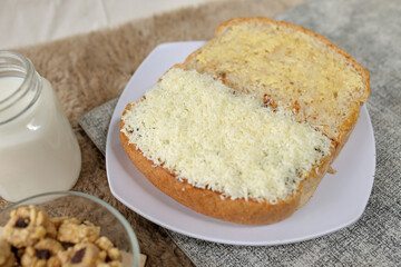 Bread with cheese, sweetened condensed milk, and butter. With white milk and snack on a table for breakfast	
