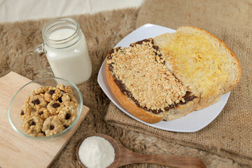 Bread with peanut, chocolate and butter spread on a table for breakfast	
