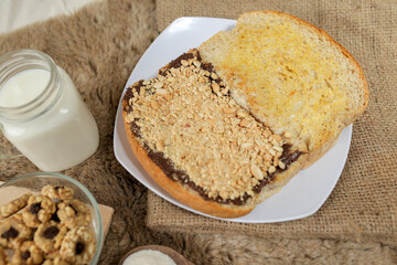 Bread with peanut, chocolate and butter spread on a table for breakfast	
