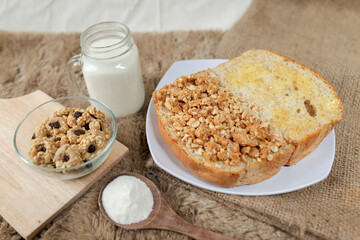 Bread with peanut and butter spread on a table for breakfast

