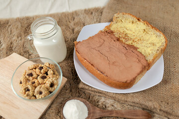 Bread with choco powder and butter on a plate for breakfast	
