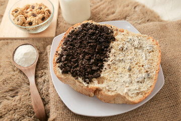Bread with chocolate cookies oreo cheese and butter spread on a plate for breakfast	
