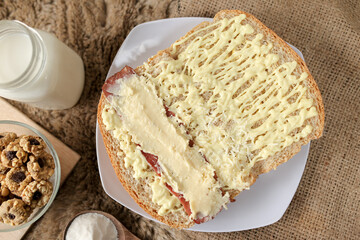 Bread with smoked beef and mozarella cheese on a plate for fast food breakfast or coffee break.