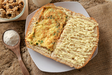 Bread with scrambled egg sandwich on a plate for breakfast and coffee break