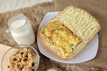 Bread with scrambled egg sandwich on a plate for breakfast and coffee break