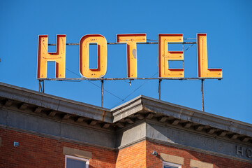 Hotel sign on an old brick hotel on small town main street. 