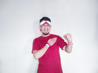 Indonesian man clenches fist with excited and happy expression on independence day
