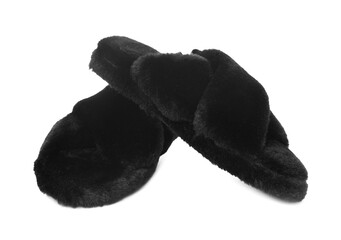 Pair of black fluffy slippers isolated on white