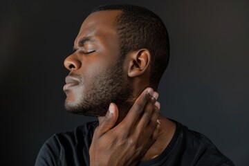 Man experiencing neck pain, holding his neck.