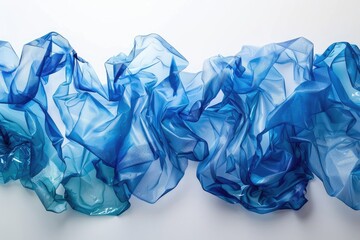 Crumpled plastic bottles for recycling on white background, closeup. throne made of used blue empty water bottle texture. Studio shot with copy space and focus stacking effect. Closeup.