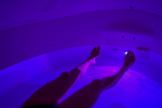 Legs of a person in a float sensory deprivation pod