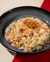 Fried rice is a dish of rice fried in a pan which produces a different taste because it is mixed with spices such as certain spices and sweet soy sauce.