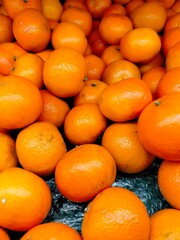 Ripe orange. Stacked citrus fruits are sold at supermarkets. Sweet fruits are fresh and healthy.