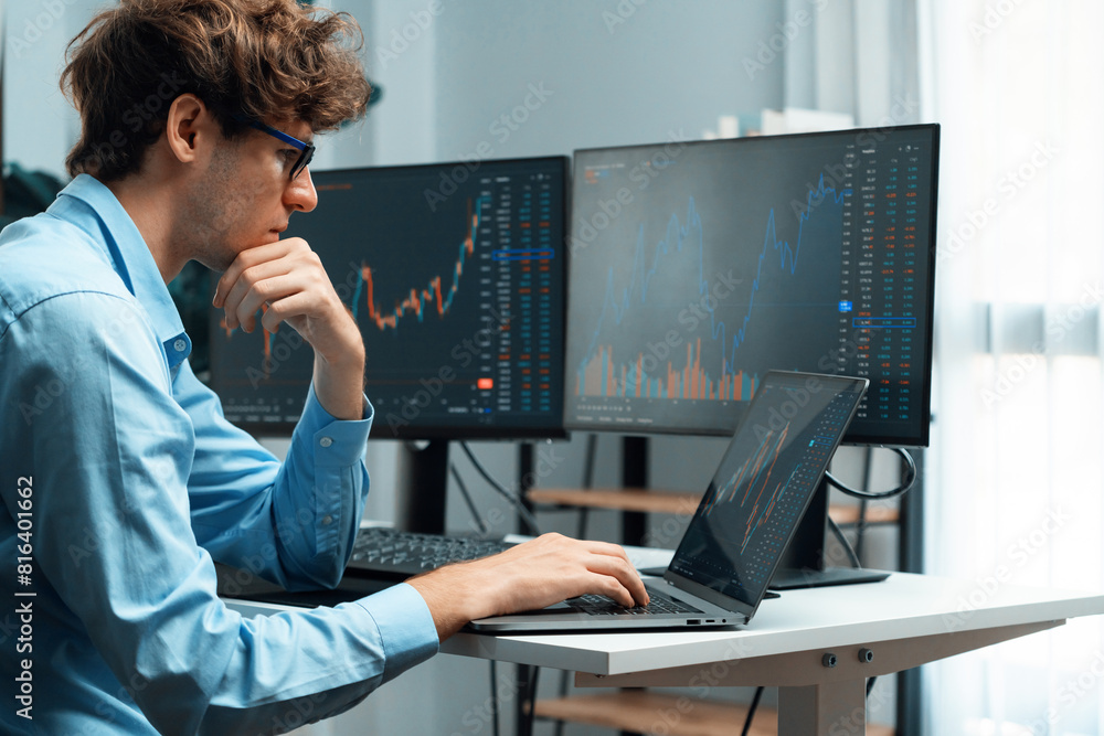 Aufkleber working young business trader focusing on market stock graph data investment in real time laptop in 