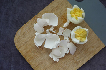 Broken egg shell on wooden cutting board, 