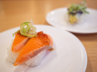japanese traditional food sushi on the white plate at the conveyor belt sushi restaurant in japan